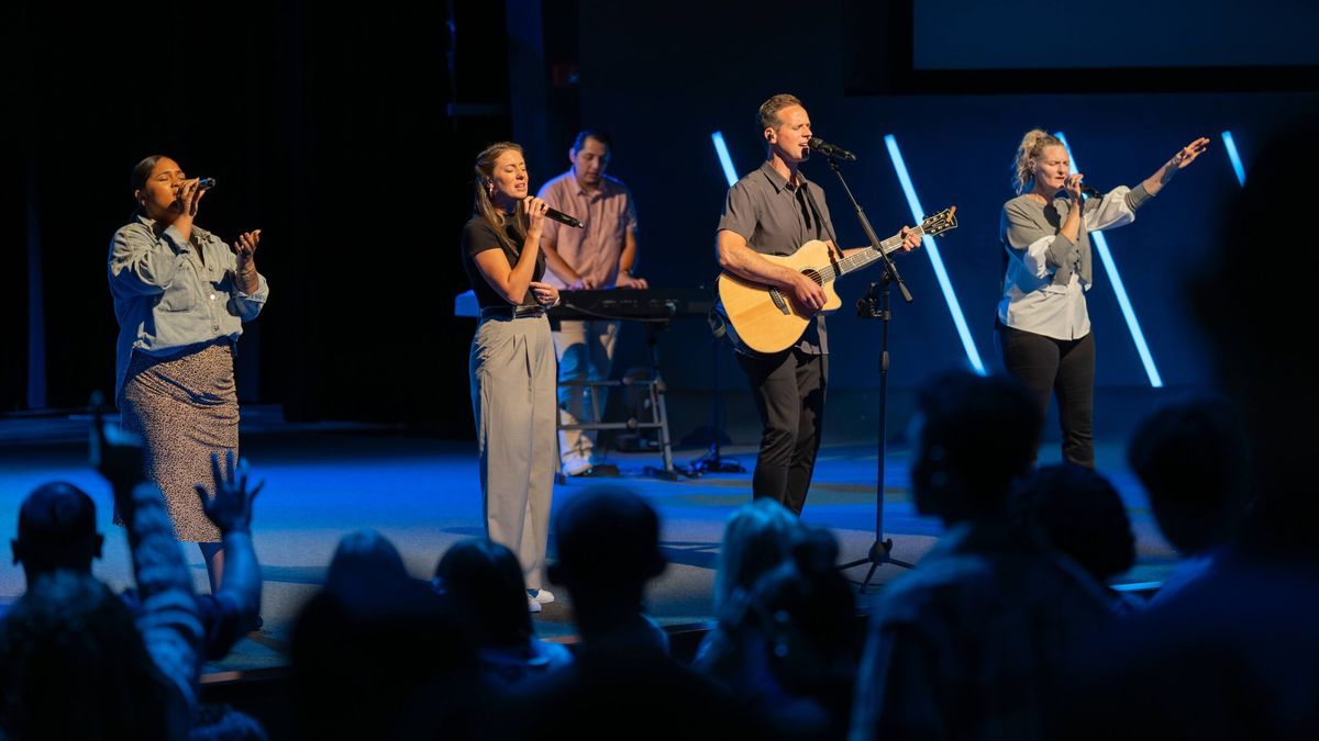 The worship team leads the congregation from the stage